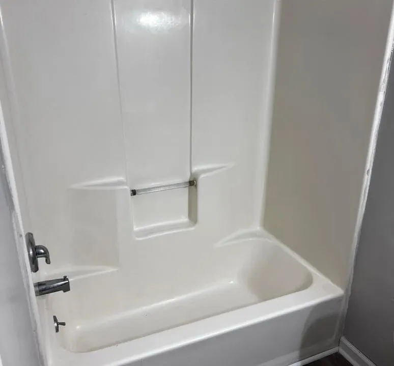 Same tub and shower surround gleaming white after deep cleaning