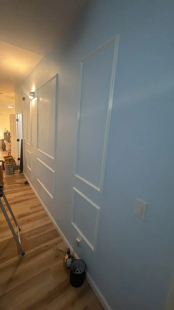 Hallway wall with freshly painted picture-frame trim molding