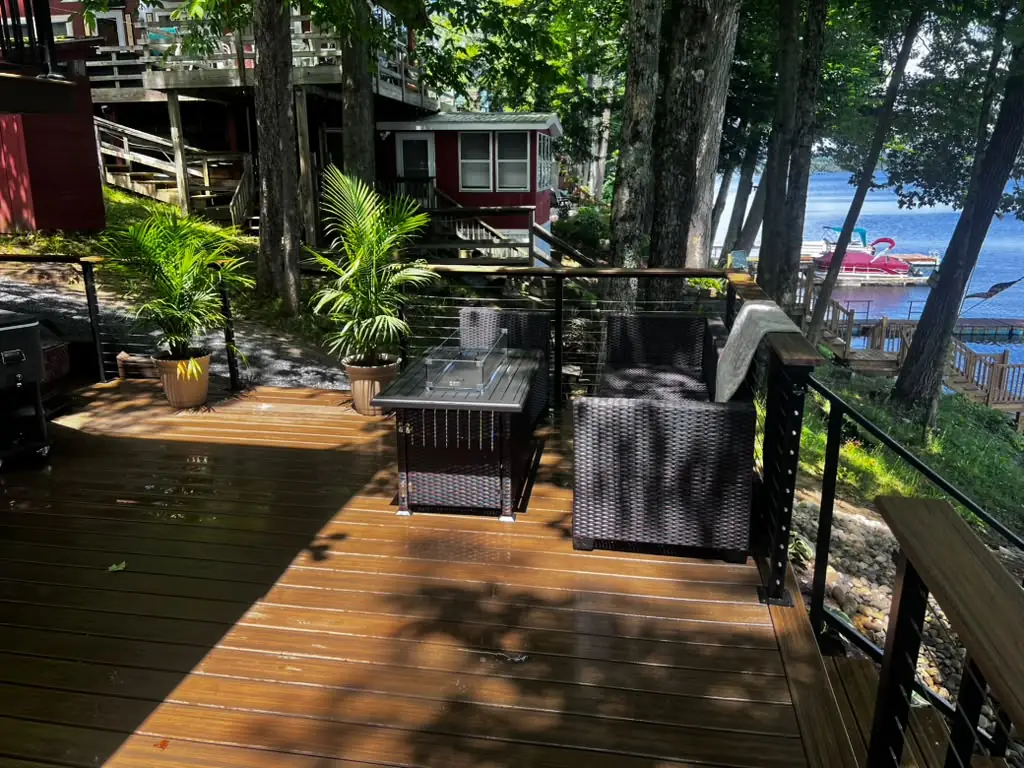 Power washed lakeside deck with fire table, palms and boats on the water